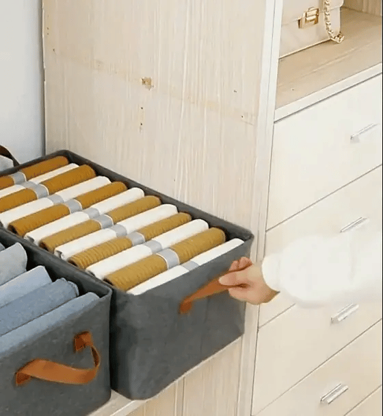 A filled box being pulled out of a shelf by its handle