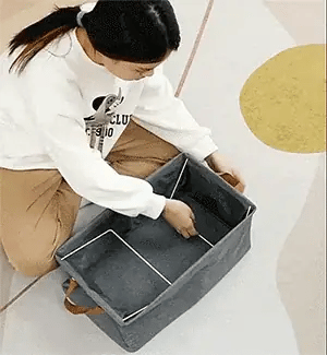 A folded box being opened into shape